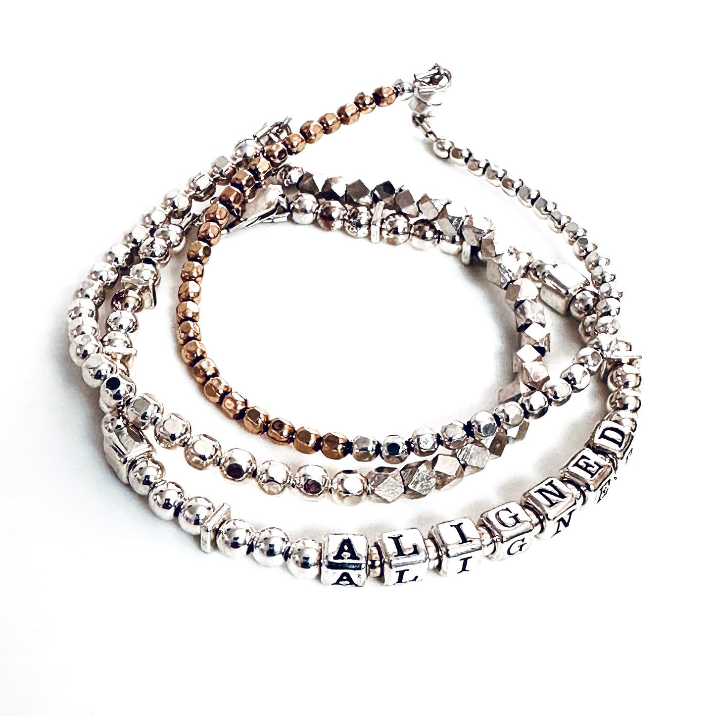 Sterling Silver Engraved Message Bracelet spelling out Aligned shown with additional sterling silver  and gold stacking  bracelets