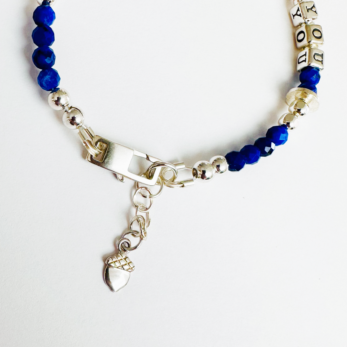 Be True, Be You Sterling Silver Bracelet with blue lapis lazuli gemstones, showing close-up of acorn charm