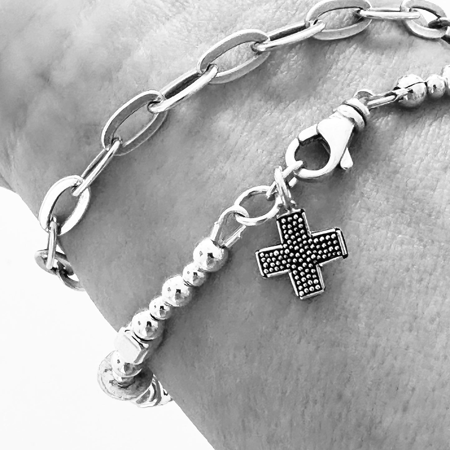 cross charm on Sterling silver message bracelet that spells out bible verse Matthew 28:20, "With You Always"