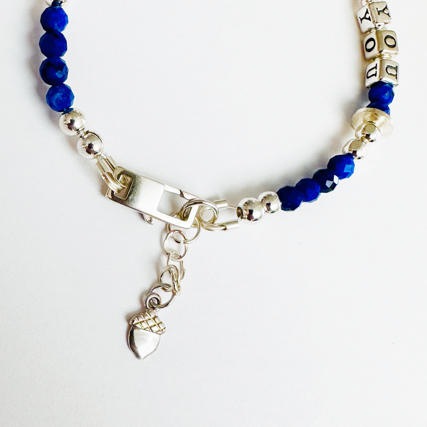 Be True, Be You Sterling Silver Bracelet with blue lapis lazuli gemstones, showing close-up of  acorn charm