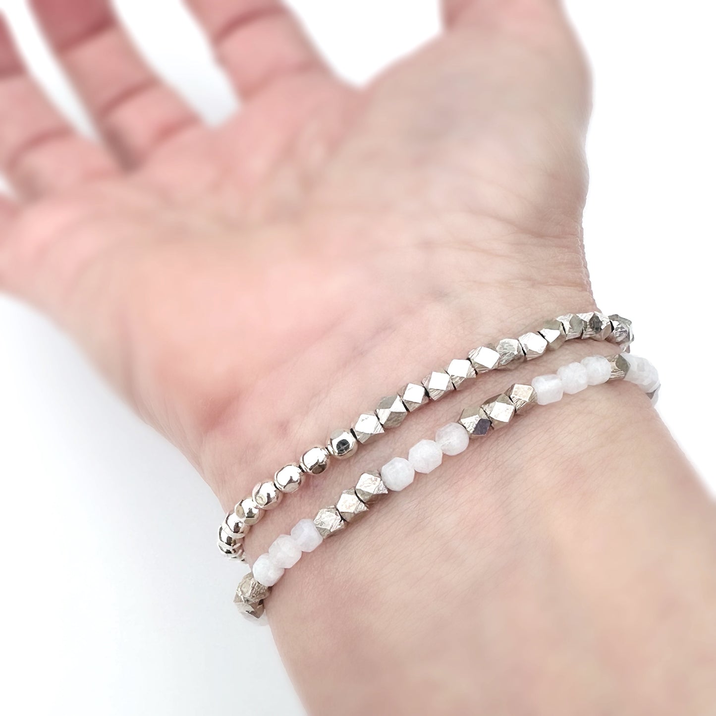 sterling silver stacking bracelet with white and silver stacking bracelet on wrist