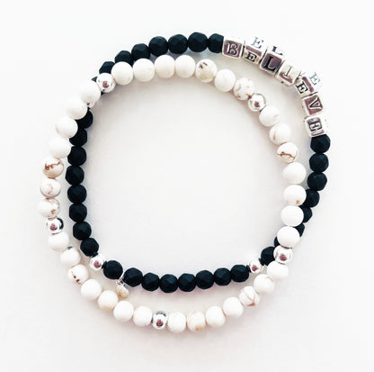 High quality sterling silver and onyx beaded elastic bracelet that spells out the word BELIEVE, shown with secondary bracelet in white howlite and sterling silver beads