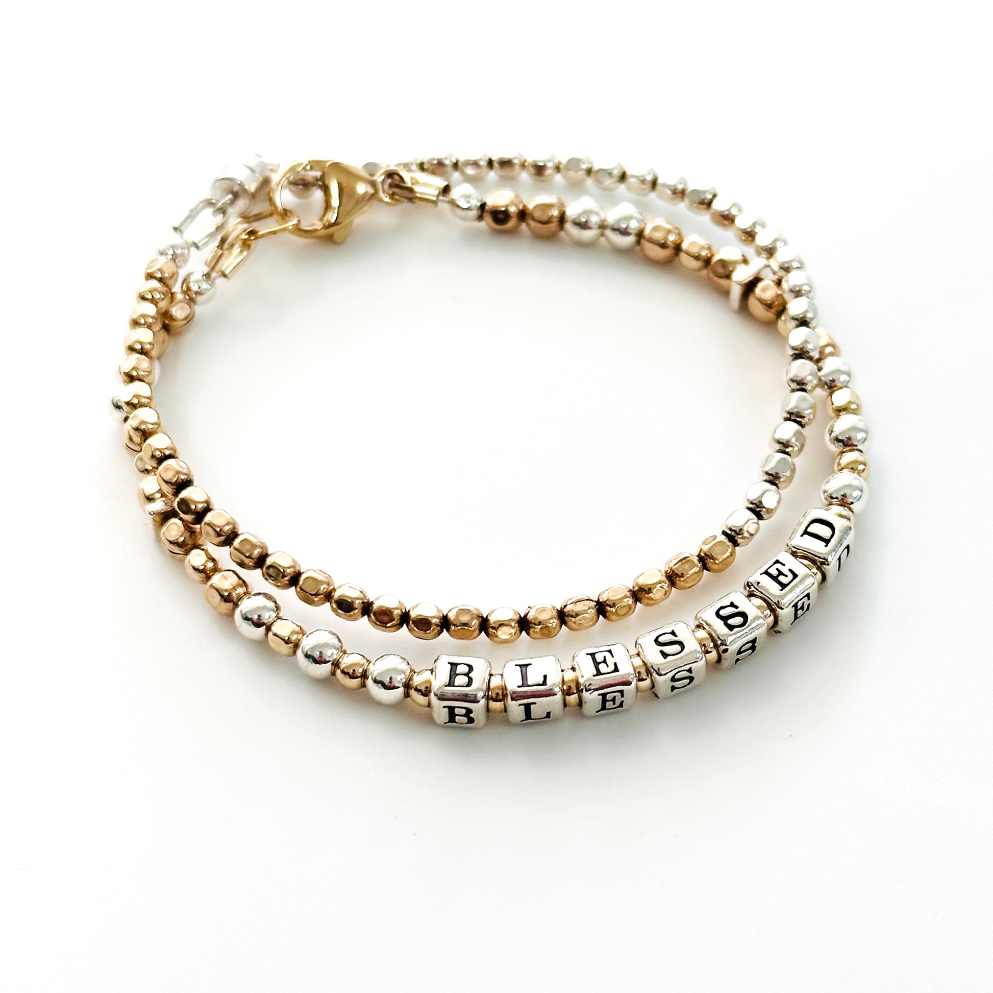Blessed Engraved Gift Bracelet in gold and silver by Higher Calling Bracelets, shown with mixed metal stacking bracelet