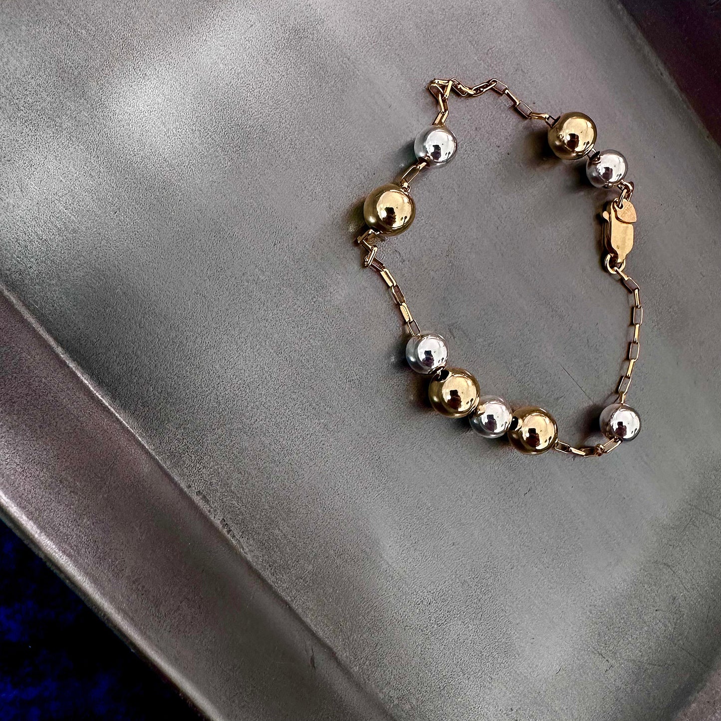 Mixed metal sterling silver and 14k gold bracelet with beads on gold chain float freely