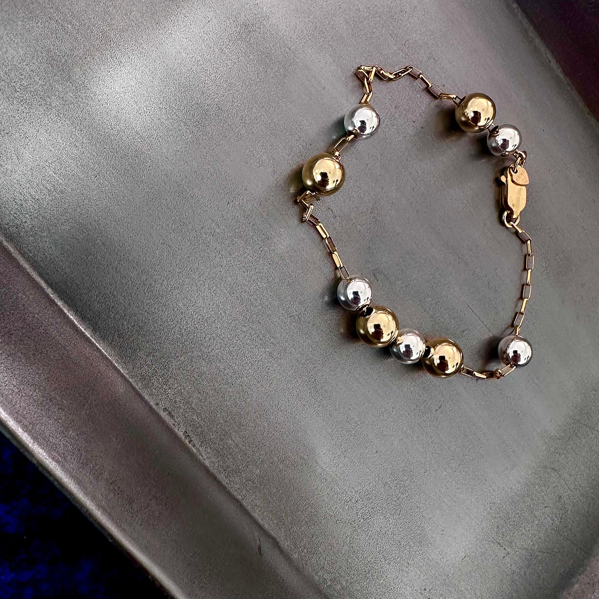 Mixed metal sterling silver and 14k gold bracelet with beads on gold chain float freely