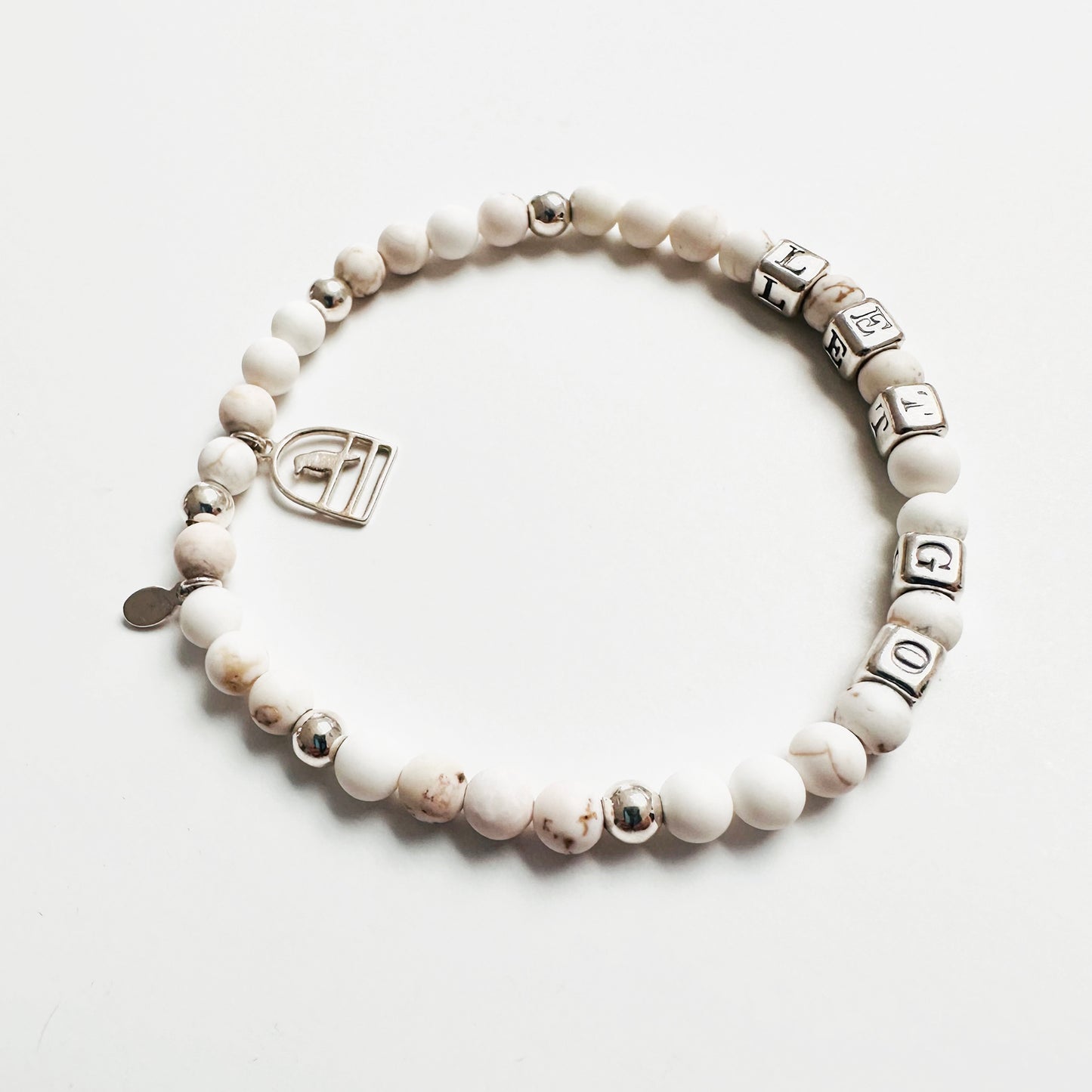 Let Go stretch bracelet in sterling silver and white howlite beads, with sterling silver bird charm