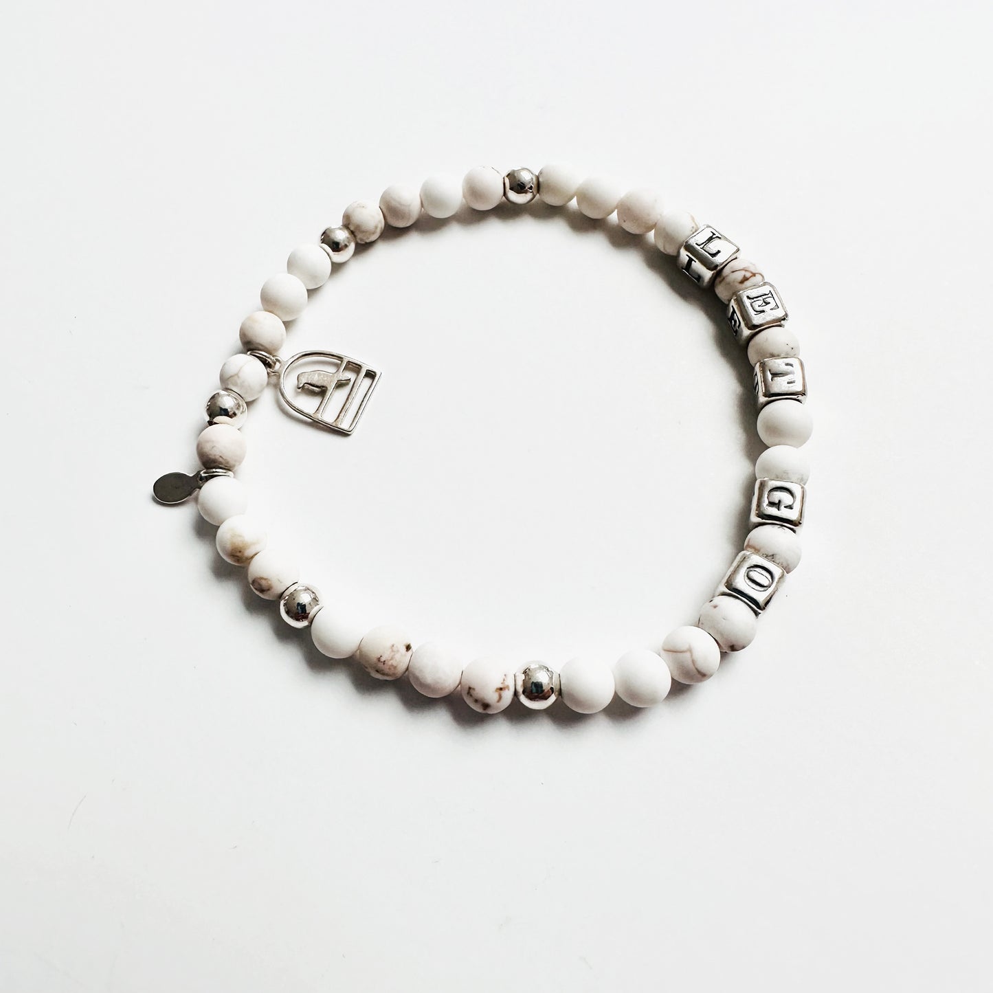 Let Go stretch bracelet in sterling silver and white howlite beads, with sterling silver bird charm