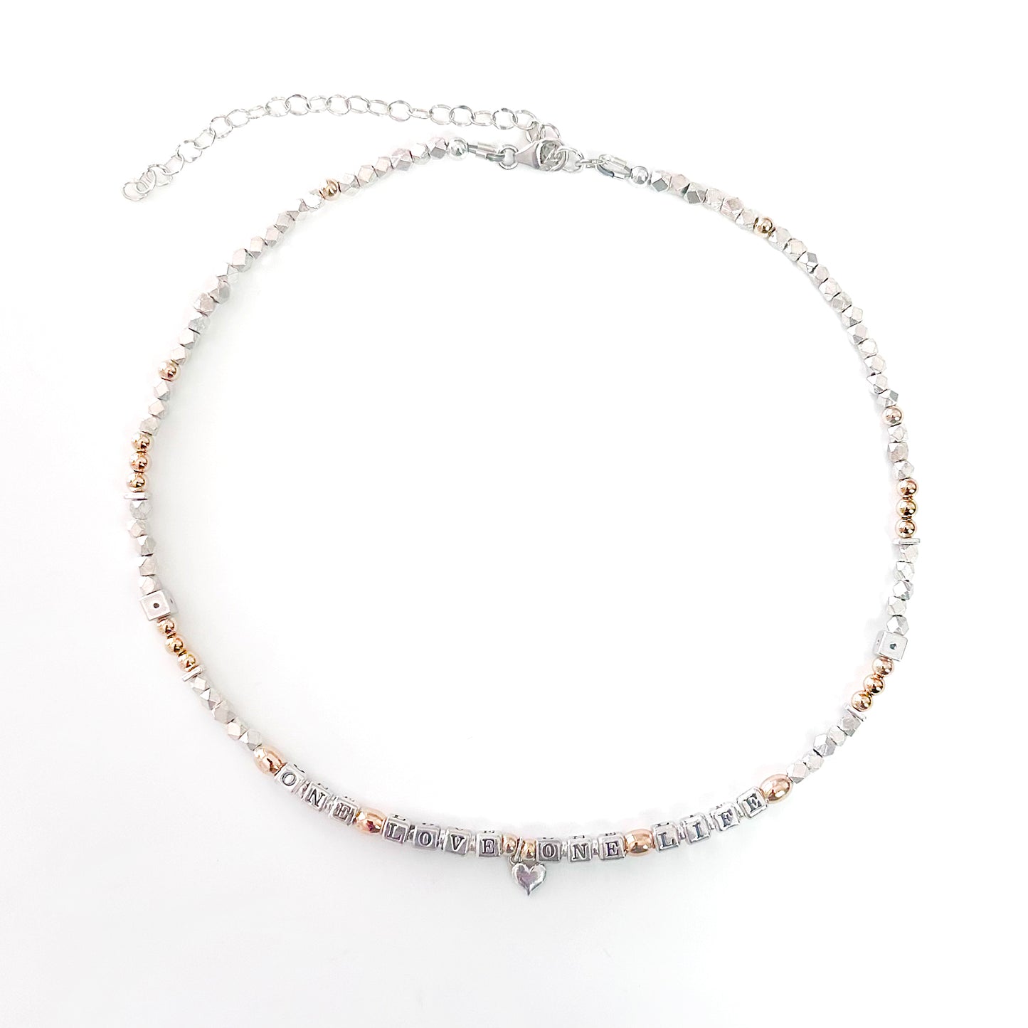 Necklace with letter beads that spell One Love One Life in sterling silver and 14k gold