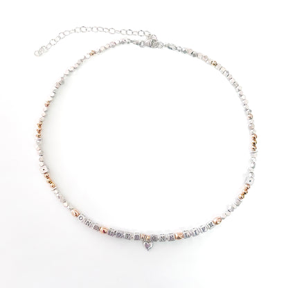 Necklace with letter beads that spell One Love One Life in sterling silver and 14k gold