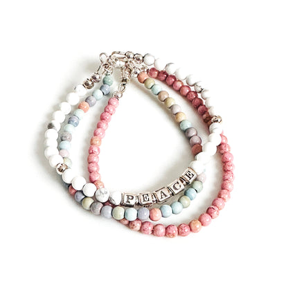 stack of pastel beaded easter bracelets with peace bracelet