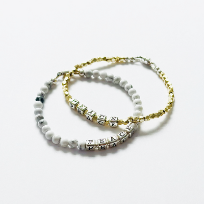 sterling silver Peace bracelet and white gemstones, shown with Gold Peace bracelet