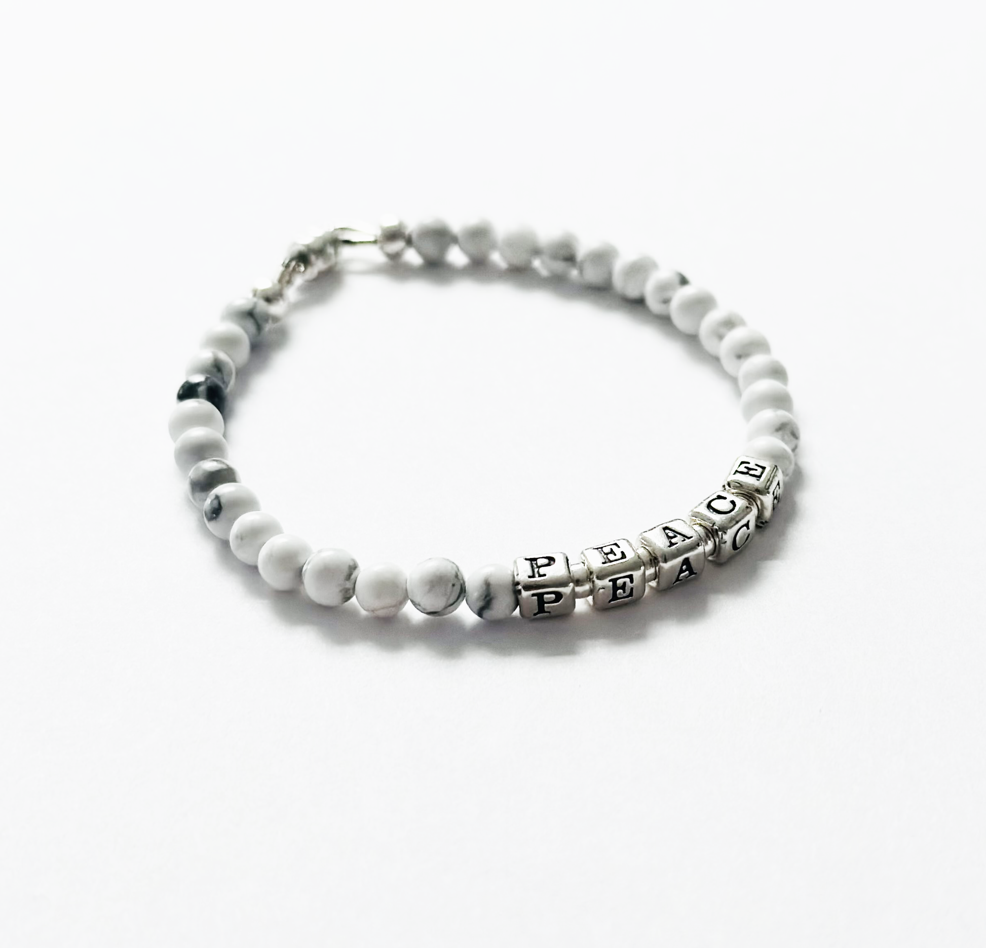 sterling silver peace bracelet with white gemstones