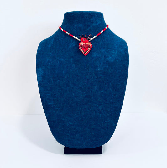 Statement necklace featuring red heart made from a circuit board, and red and sterling silver beads, shown on mannequin