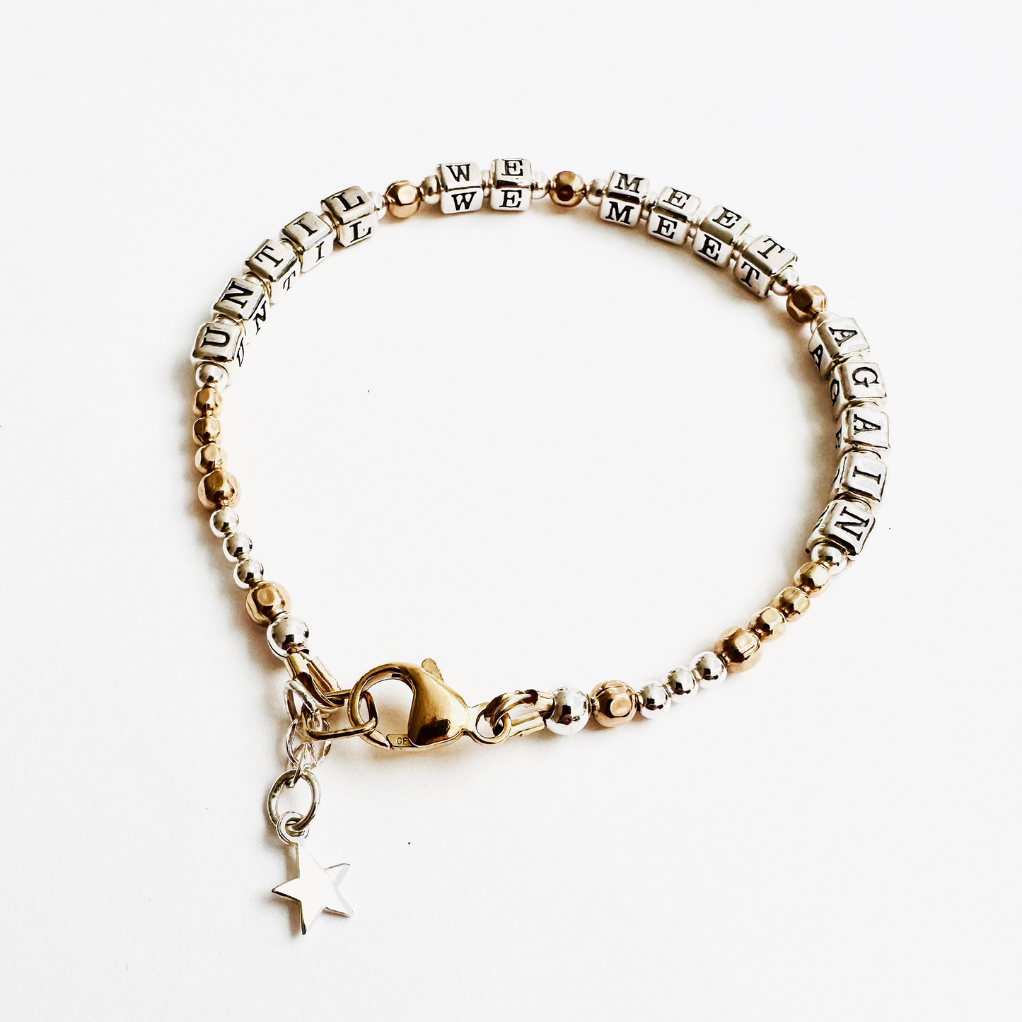 Sympathy or Grief Gift Bracelet says "Until We Meet Again" in sterling silver and gold., with a sterling silver charm detail
