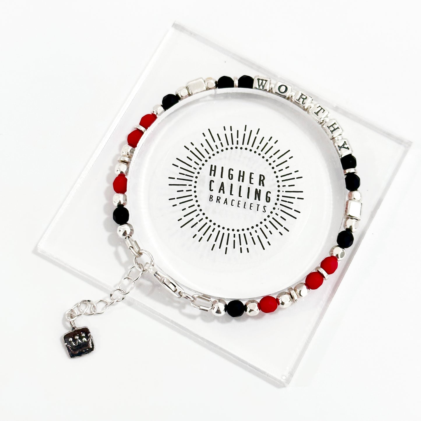 sterling silver Worthy bracelet with black onyx and red stones, and featuring a small crown charm