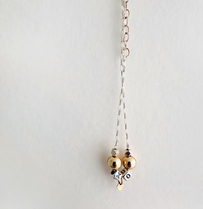 Delicate necklace with sterling silver and 14k gold beads and heart, spells out XO for hugs and kisses