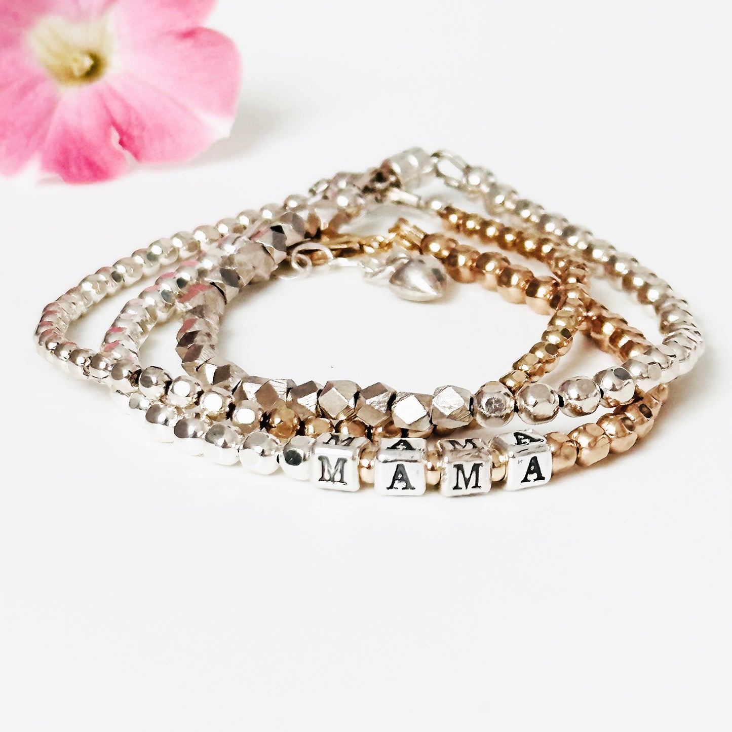 Mama Mother's Day word and heart bracelet in sterling silver and 14k mixed metals, shown with gold and silver stacking bracelets